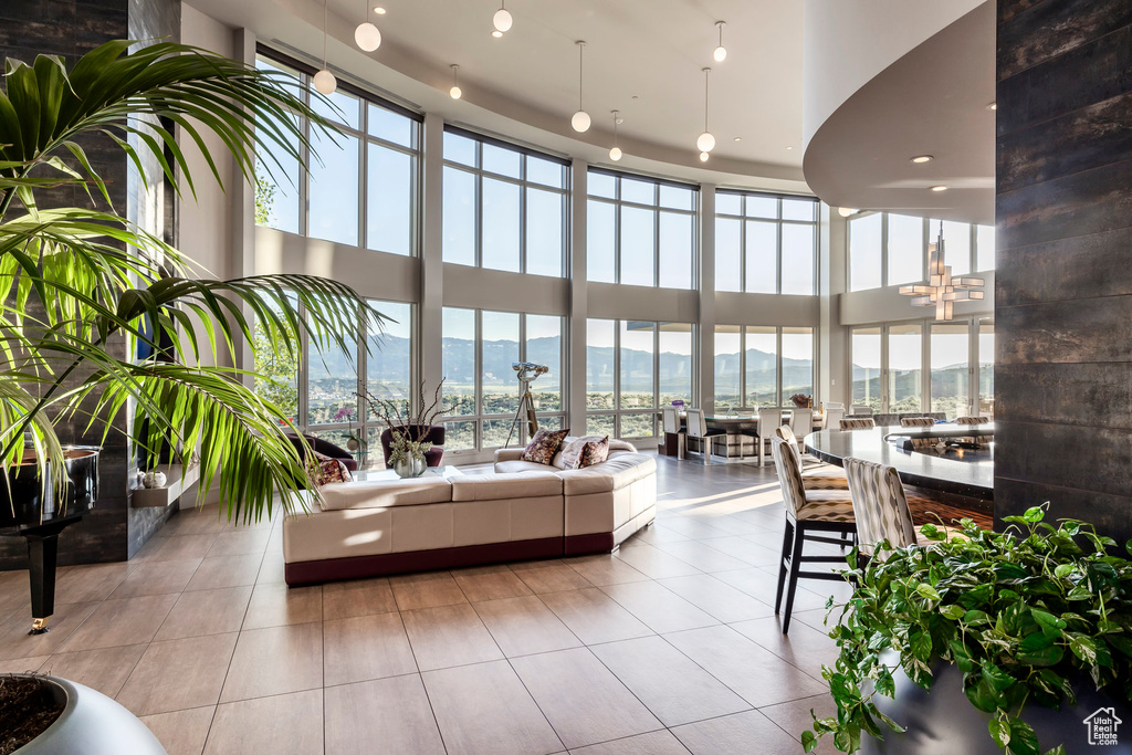 Lobby featuring a high ceiling, a mountain view, recessed lighting, and a wall of windows