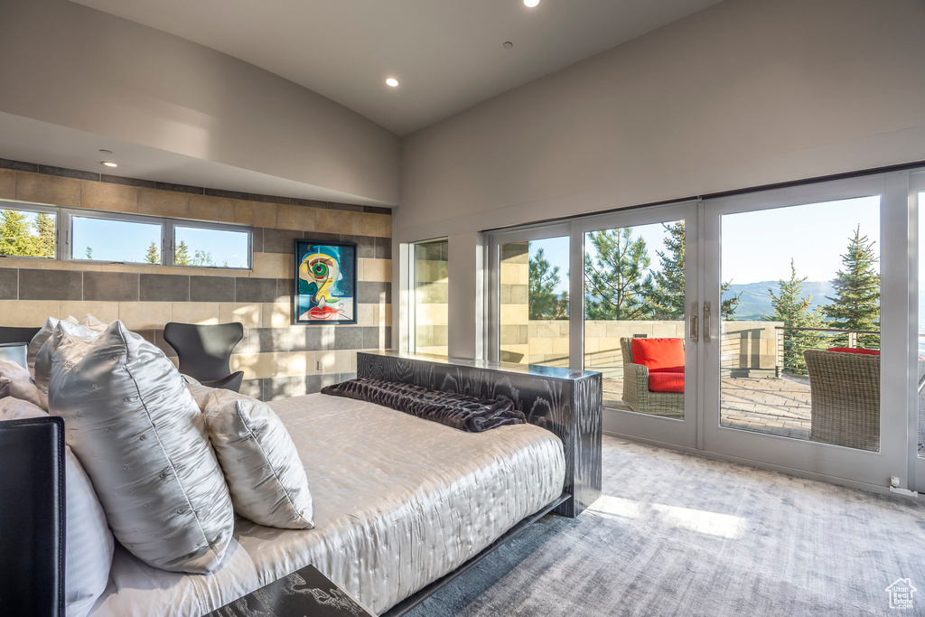 Carpeted bedroom featuring access to exterior, recessed lighting, and french doors