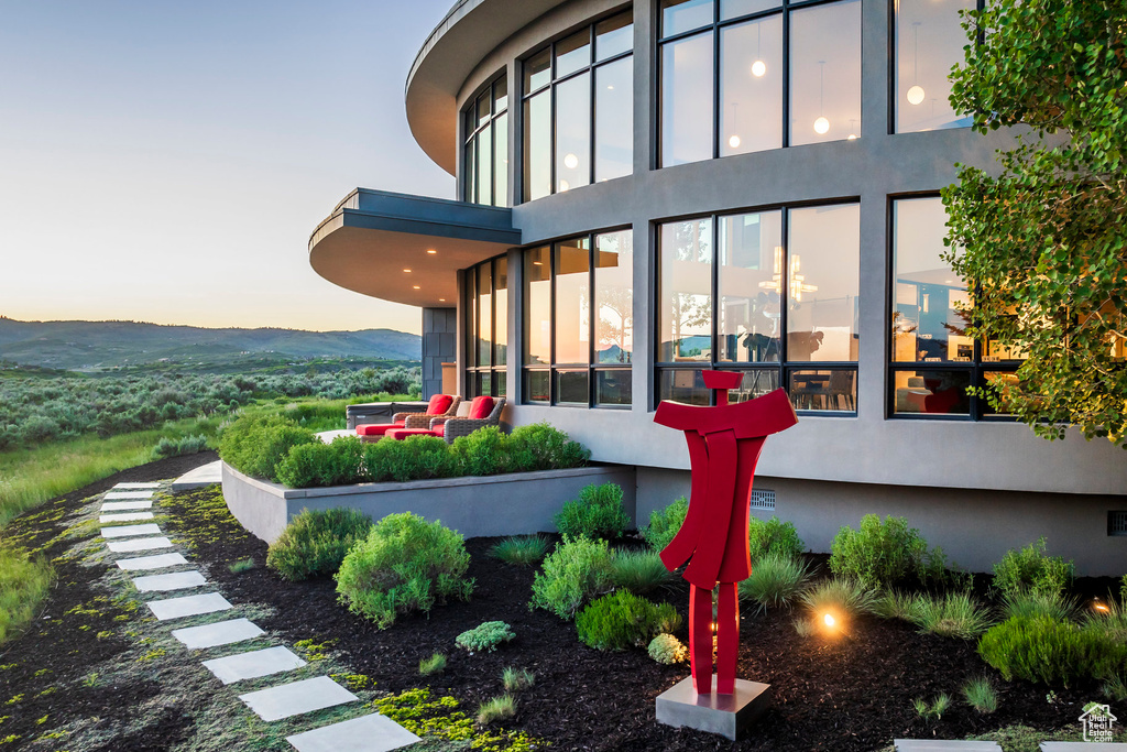 Exterior space featuring stucco siding and a balcony