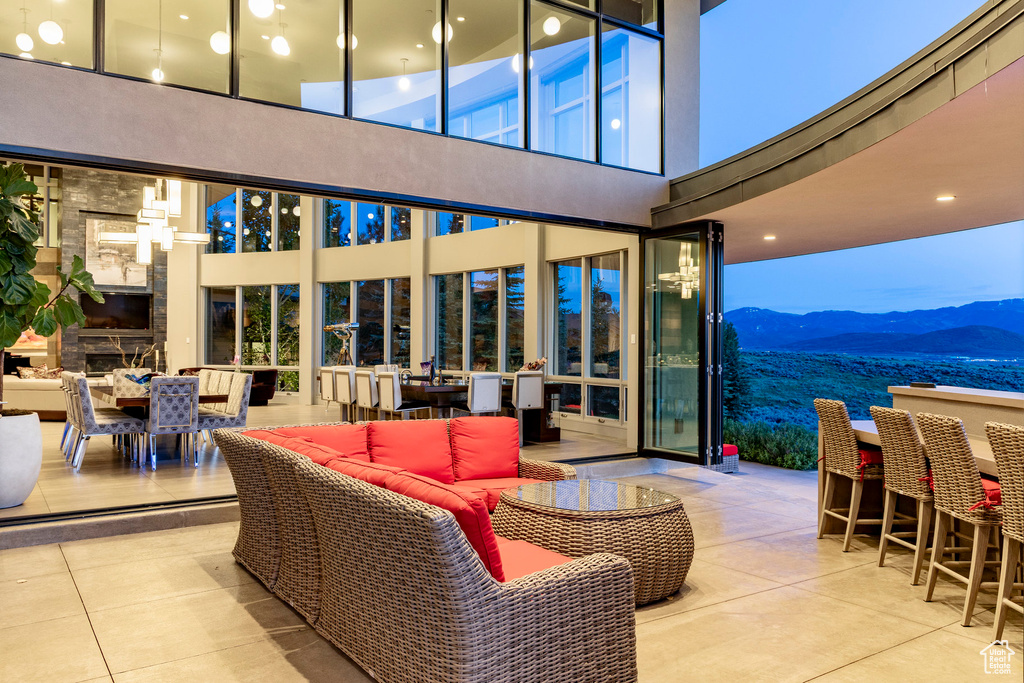 View of patio featuring an outdoor living space, outdoor dining space, and a mountain view