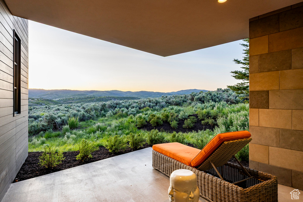 Patio terrace at dusk with a mountain view and a patio area