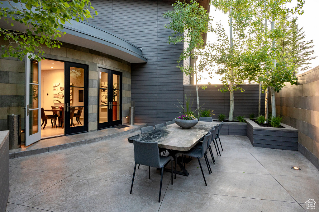 Fenced backyard featuring outdoor dining area, a patio area, and french doors