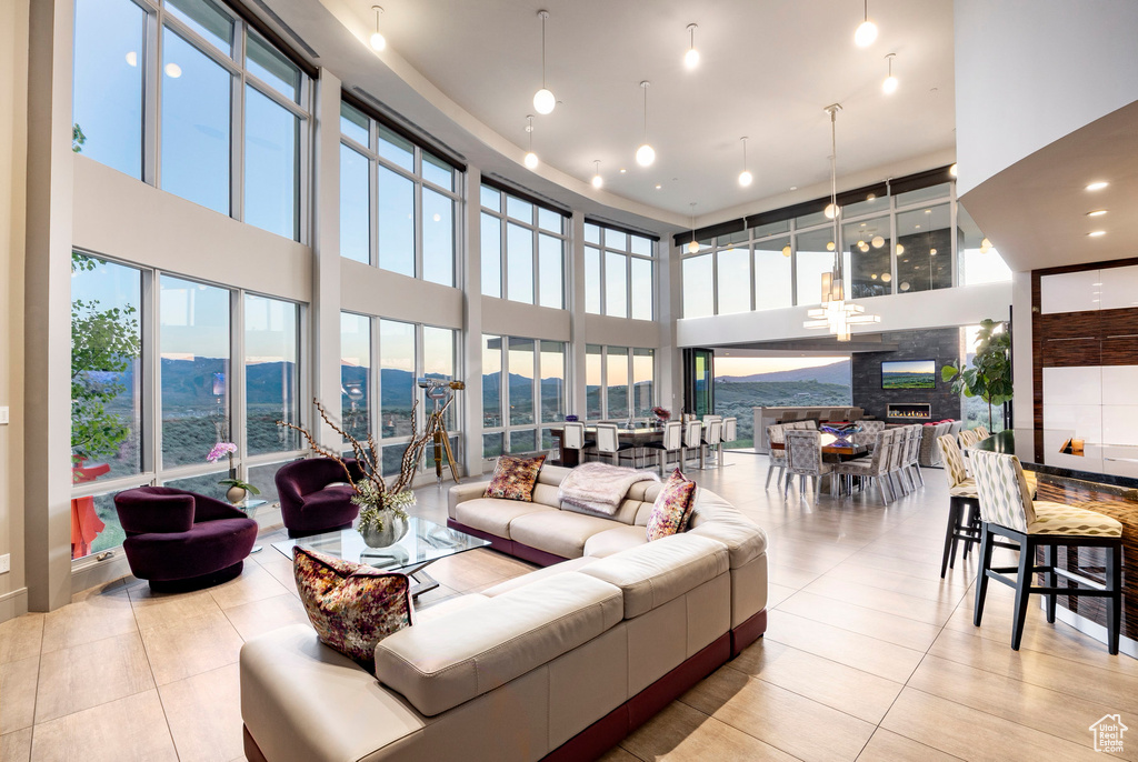 Tiled living room featuring a high ceiling and a mountain view