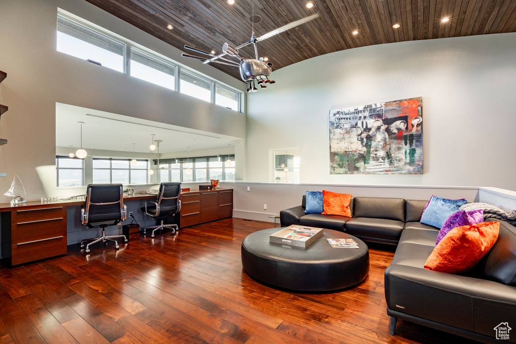 Office area featuring hardwood / wood-style floors, wooden ceiling, built in desk, recessed lighting, and a chandelier