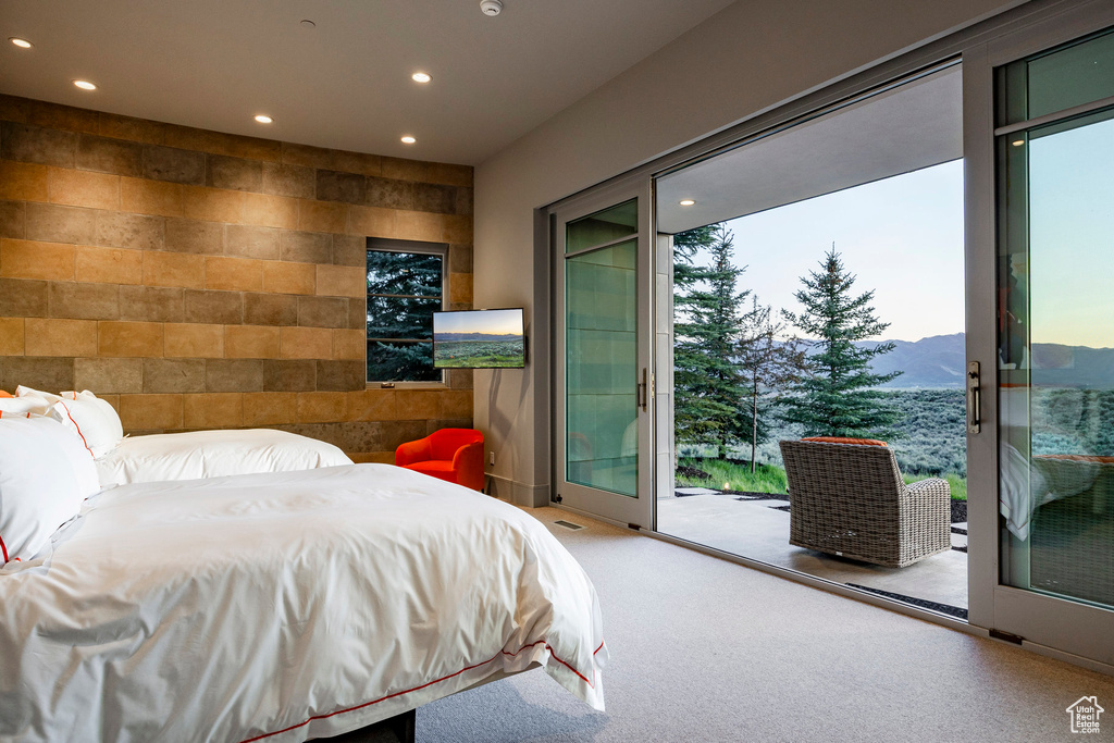 Bedroom featuring recessed lighting, access to exterior, and carpet flooring