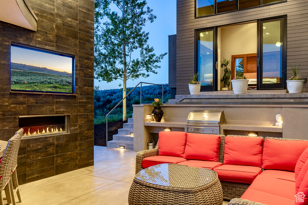 View of patio featuring an outdoor living space with a fireplace and stairway