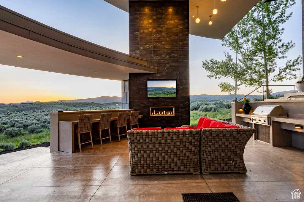 View of patio / terrace featuring an outdoor living space with a fireplace and a mountain view