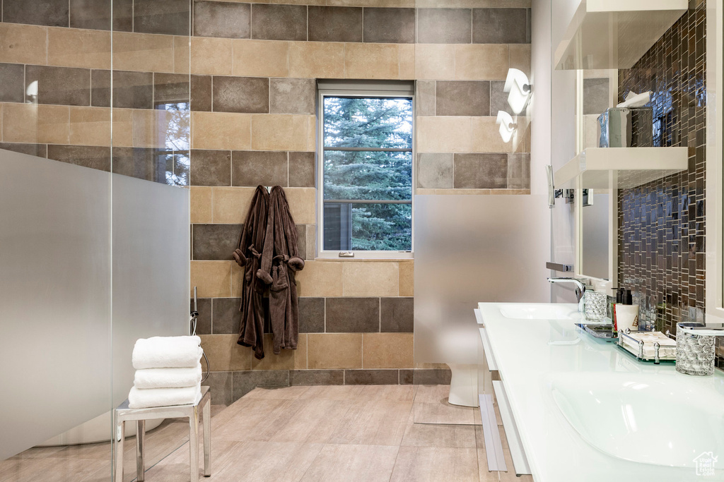 Full bath featuring double vanity