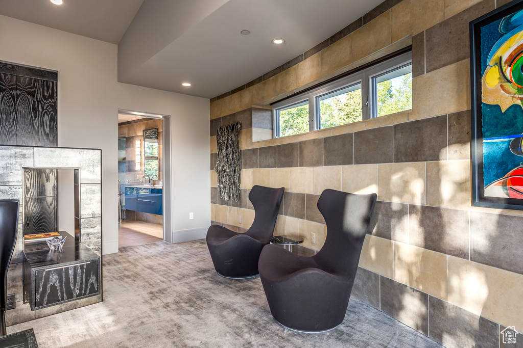 Living area with recessed lighting, baseboards, and carpet floors