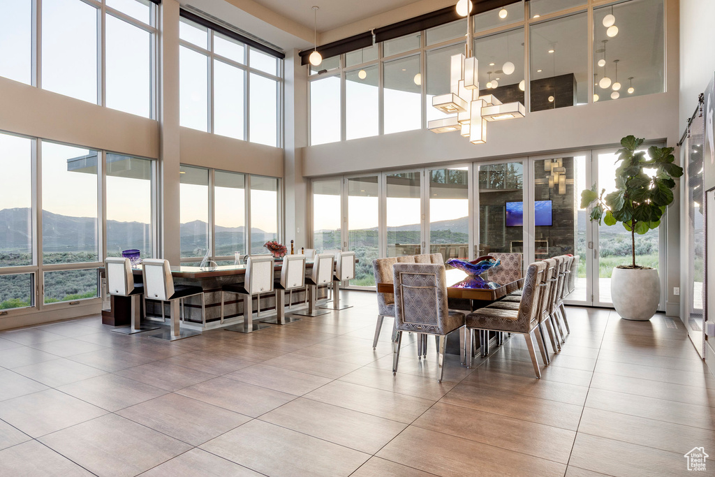 Sunroom / solarium featuring a mountain view and a chandelier