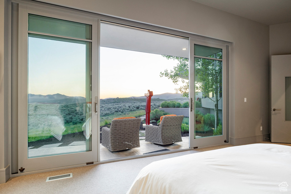 Bedroom with access to outside and a mountain view