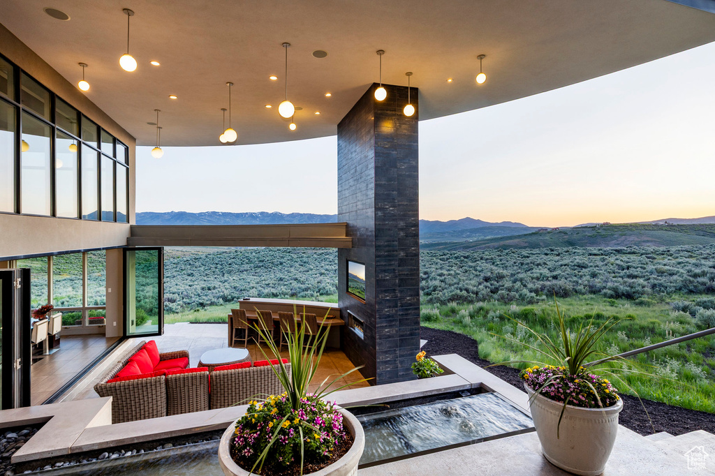 View of patio / terrace with a mountain view and an outdoor living space