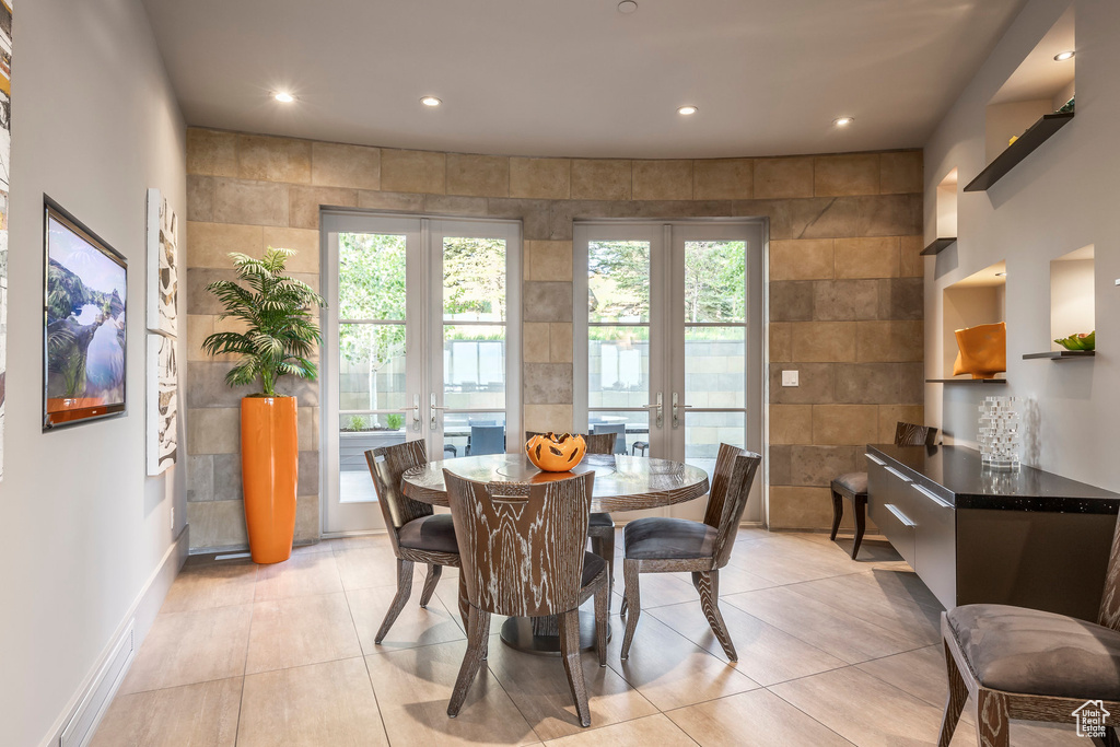 Dining space featuring french doors, recessed lighting, healthy amount of natural light, baseboards, and light tile patterned flooring