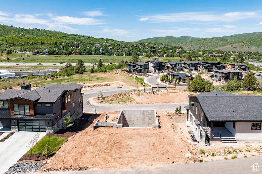 Aerial perspective of suburban area featuring a mountainous background