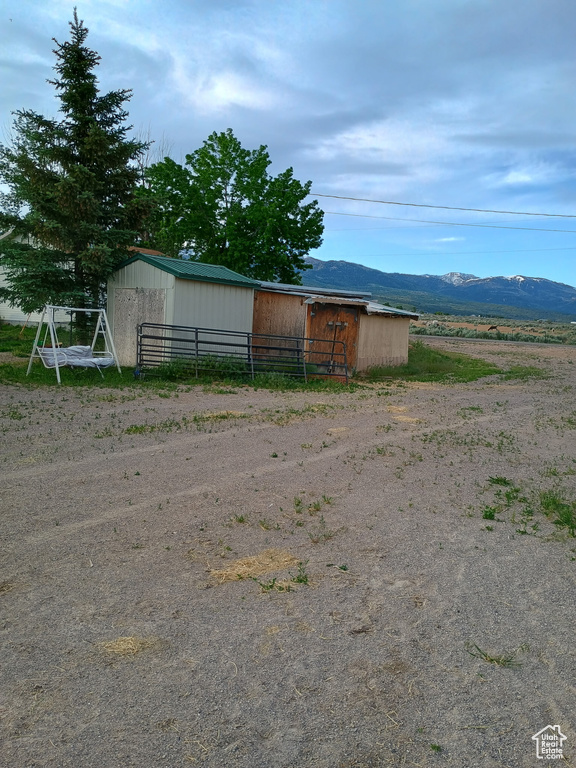 View of pole building with a mountain view
