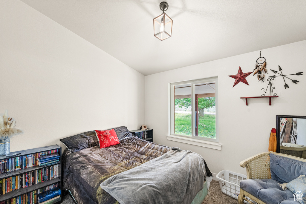 Carpeted bedroom with lofted ceiling