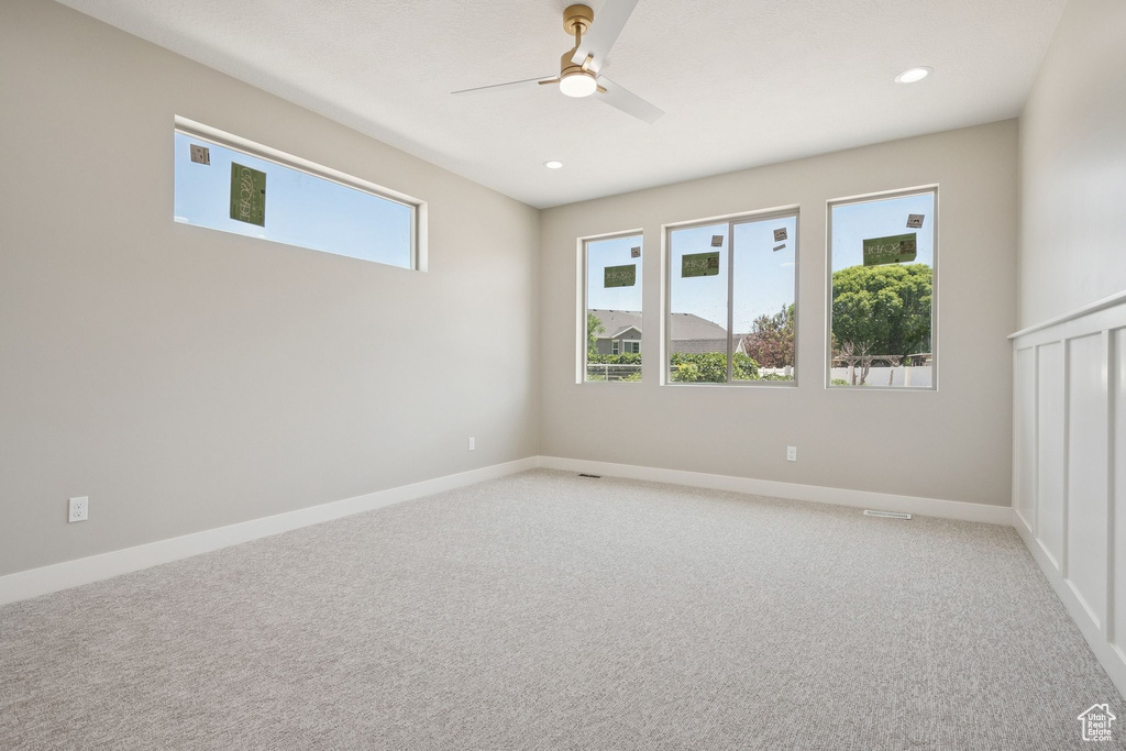 Empty room with a ceiling fan, light colored carpet, recessed lighting, and baseboards