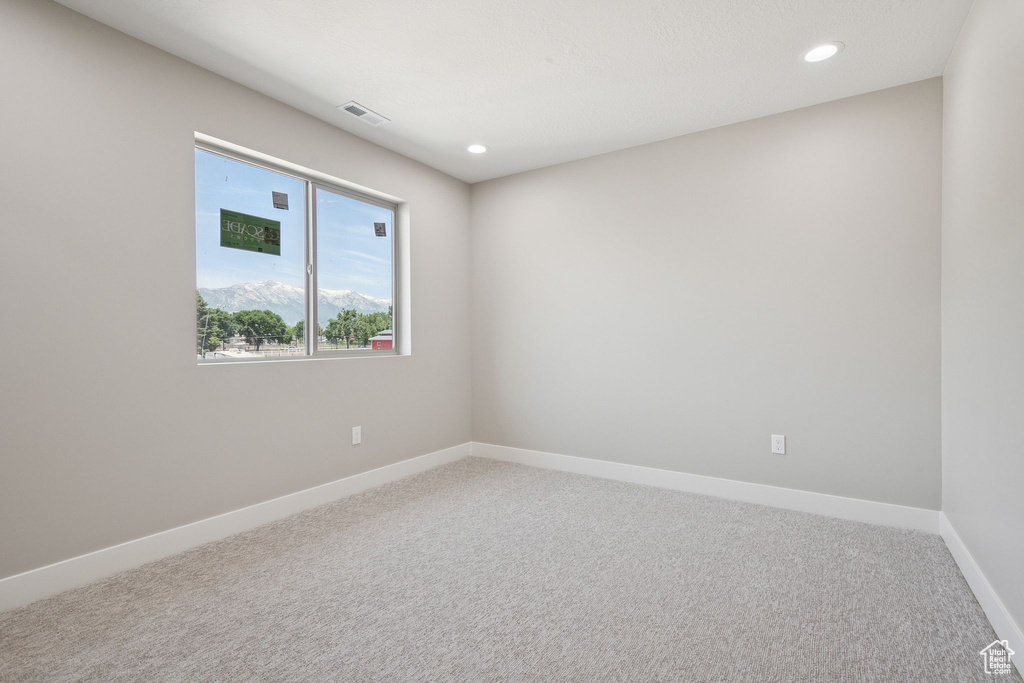 Empty room with carpet flooring, baseboards, and recessed lighting