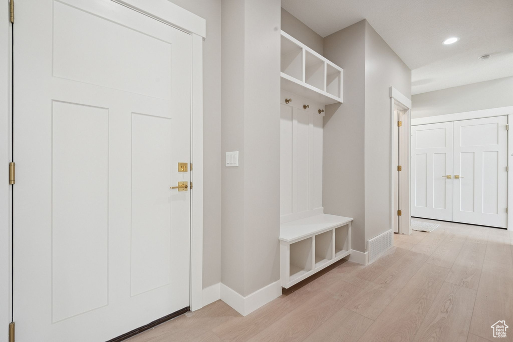 Mudroom featuring light wood-style floors, baseboards, and recessed lighting