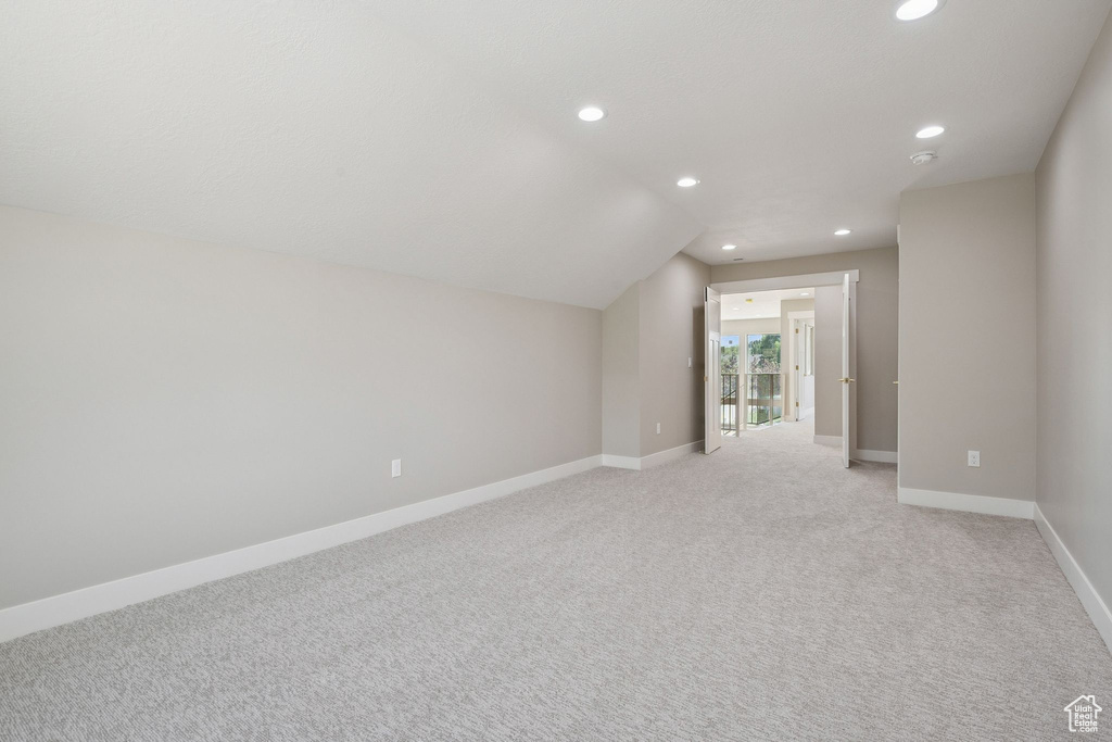 Bonus room with recessed lighting, baseboards, light carpet, and lofted ceiling
