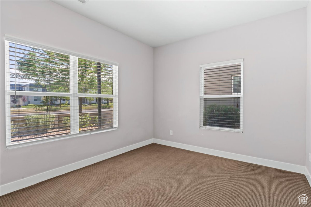 Empty room with carpet flooring and baseboards