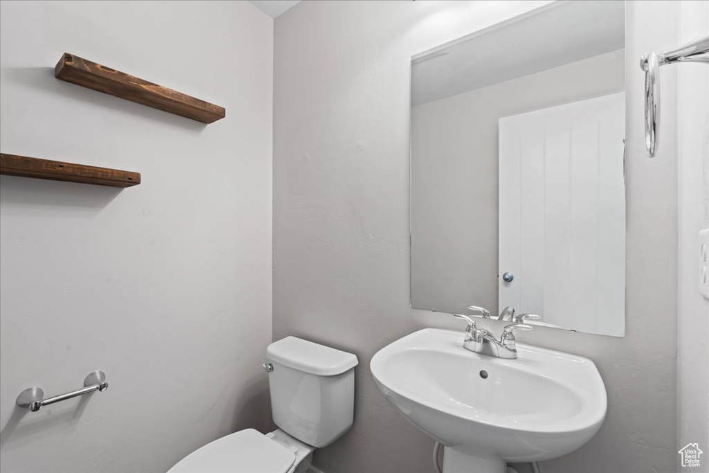 Bathroom featuring a sink and toilet