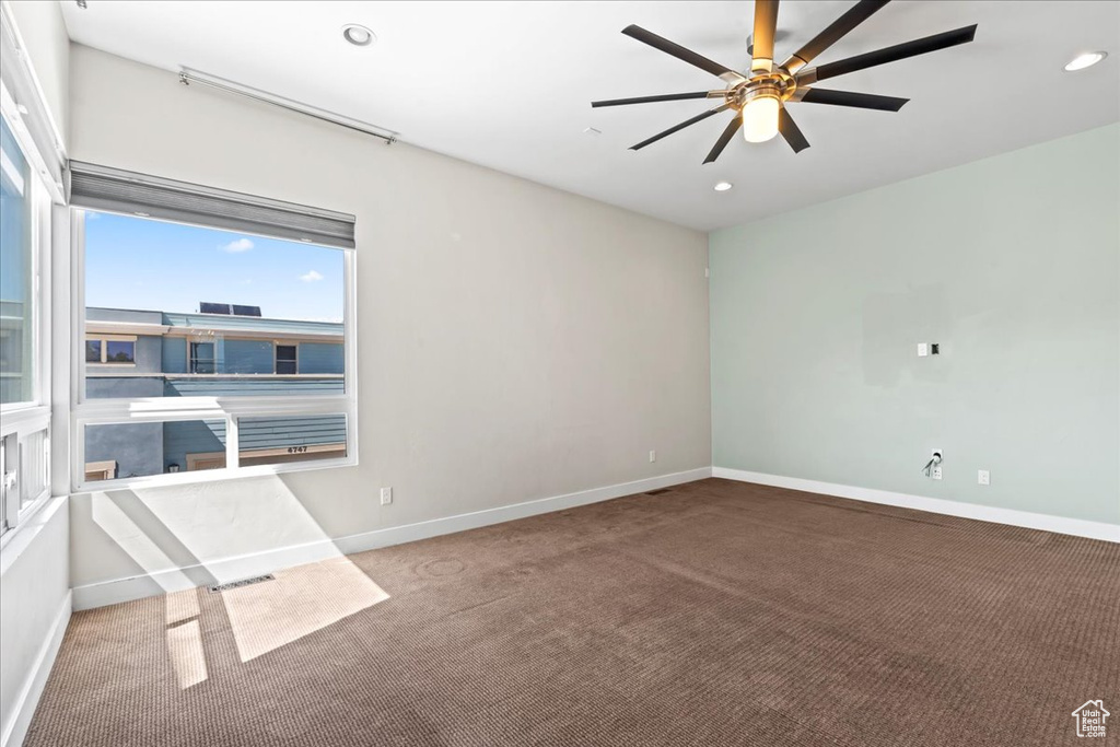 Carpeted spare room with baseboards, a ceiling fan, and recessed lighting
