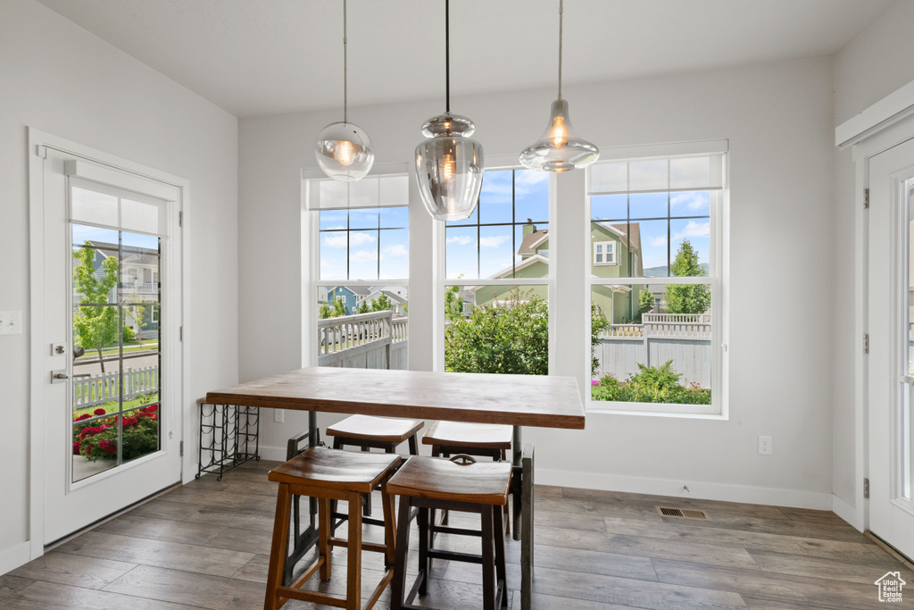 Dining room featuring plenty of natural light, wood finished floors, and baseboards