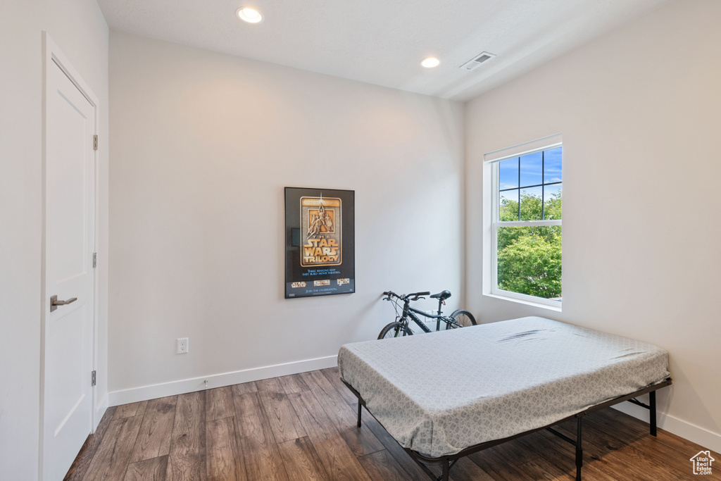 Bedroom featuring wood finished floors, baseboards, and recessed lighting