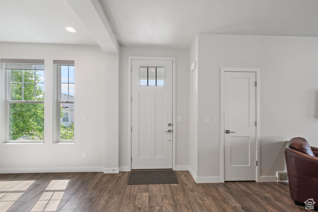 Entryway with dark wood finished floors, baseboards, and recessed lighting