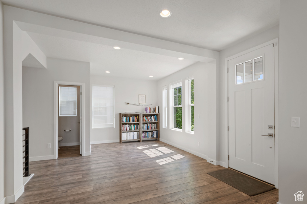 Foyer entrance featuring wood finished floors, baseboards, and recessed lighting