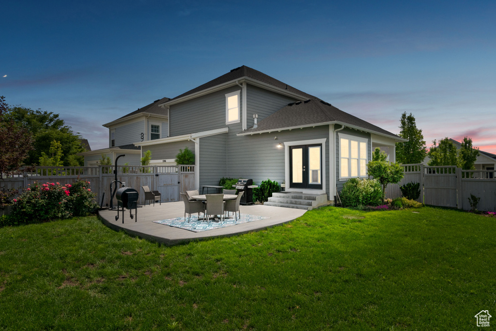 Back of house featuring entry steps, a gate, french doors, and a patio