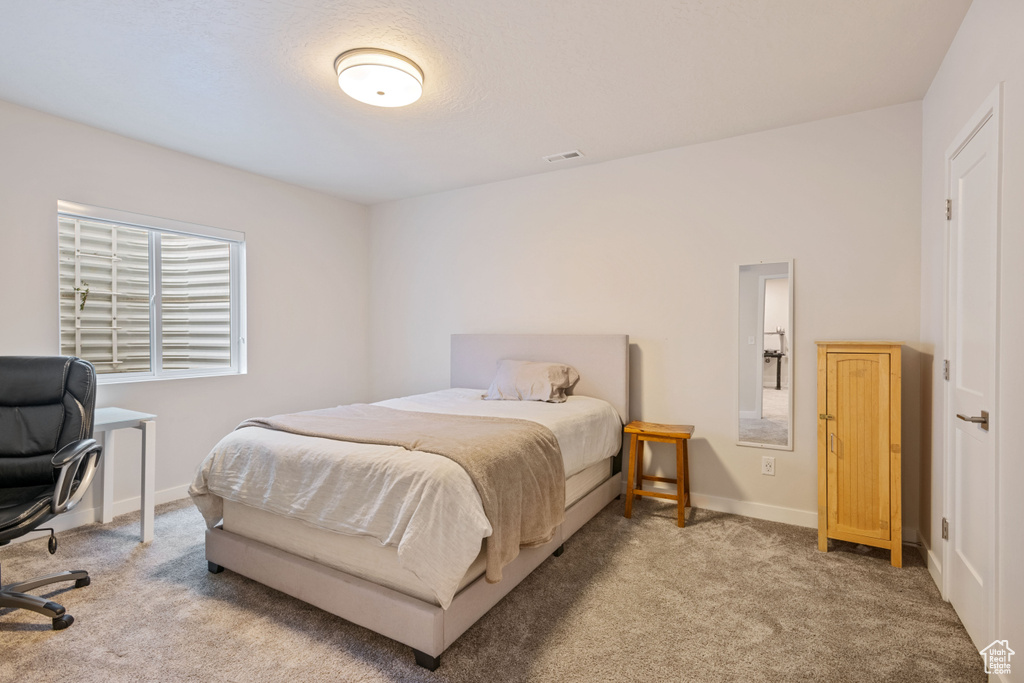 Carpeted bedroom with baseboards