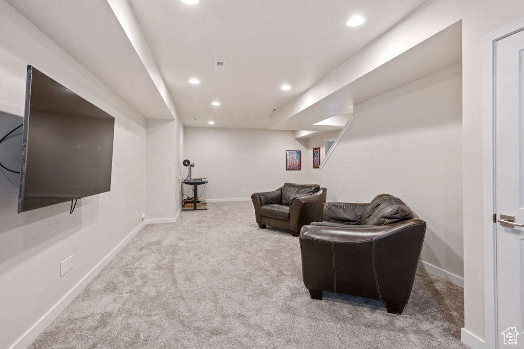 Living room featuring carpet floors, recessed lighting, and baseboards