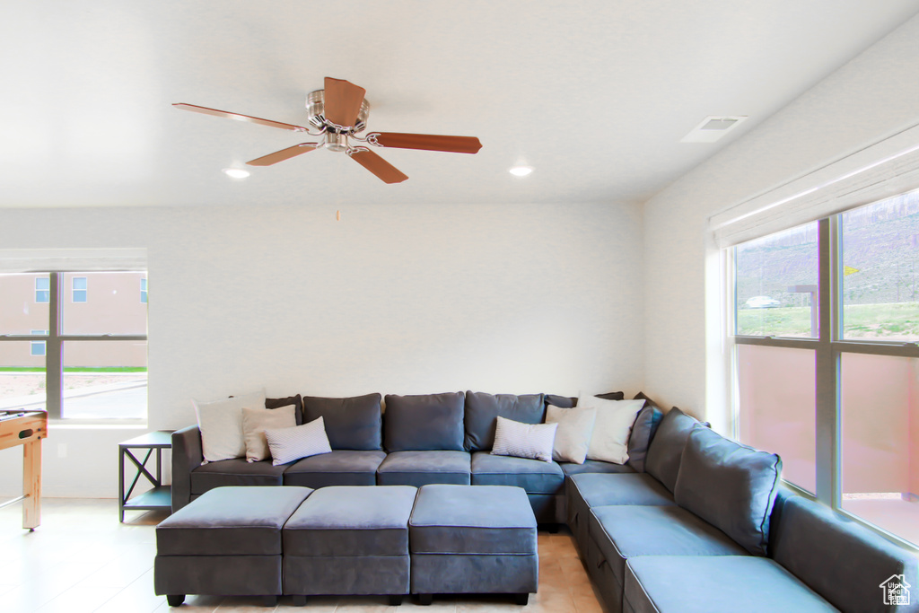 Living area with healthy amount of natural light, ceiling fan, and recessed lighting