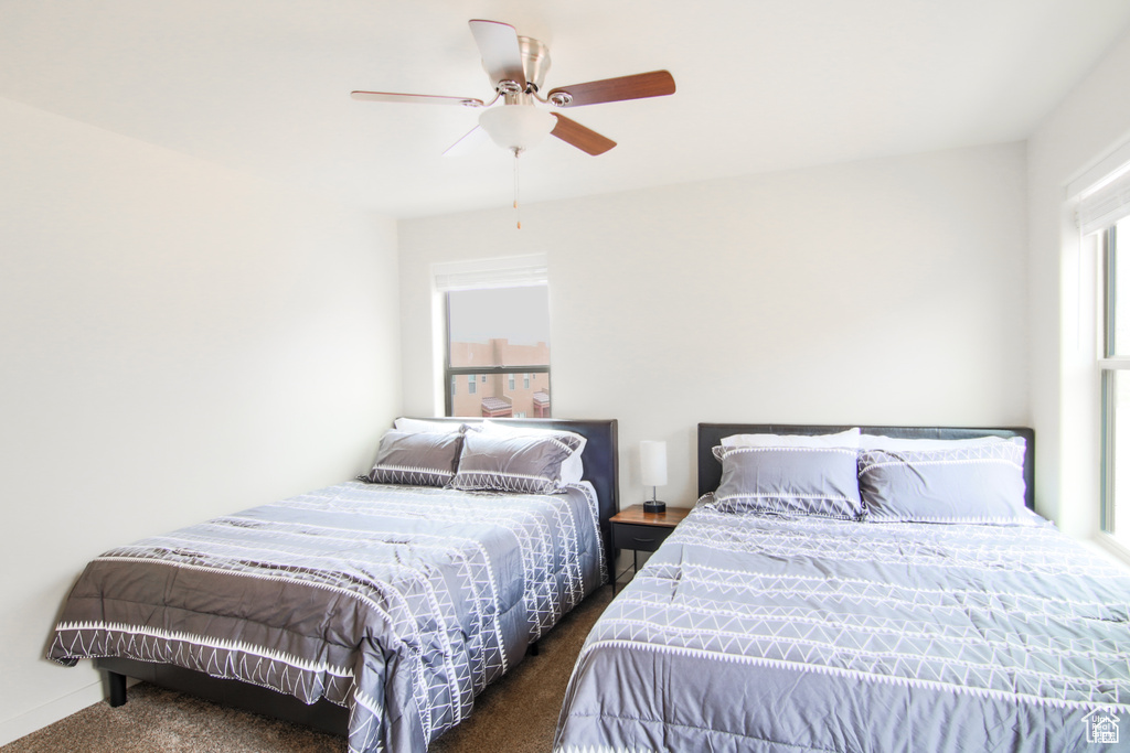 Bedroom with carpet flooring, ceiling fan, and baseboards