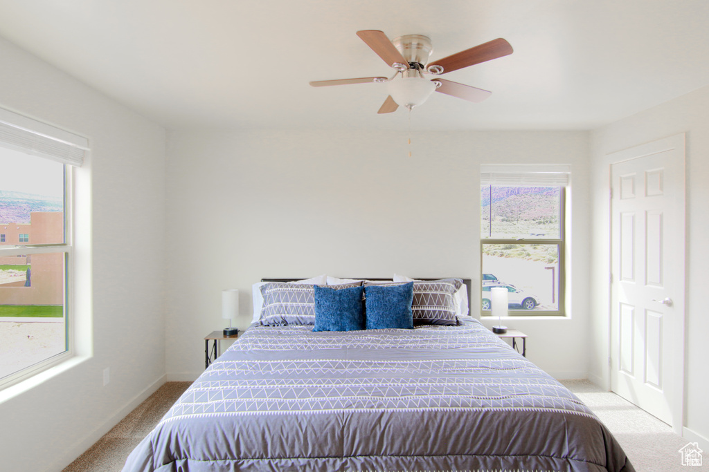 Bedroom featuring carpet flooring, ceiling fan, and baseboards