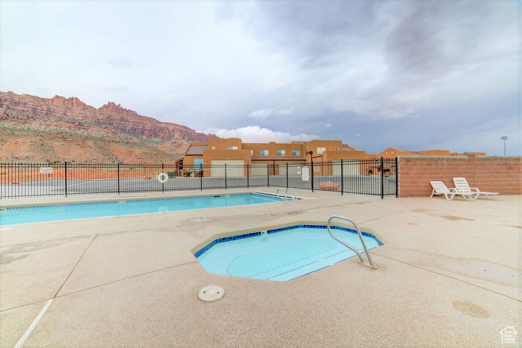 Community pool with a mountain view and a patio