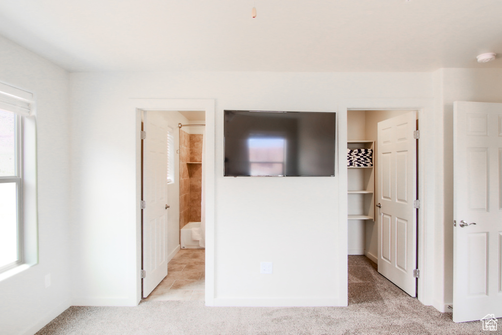 Unfurnished bedroom with light colored carpet