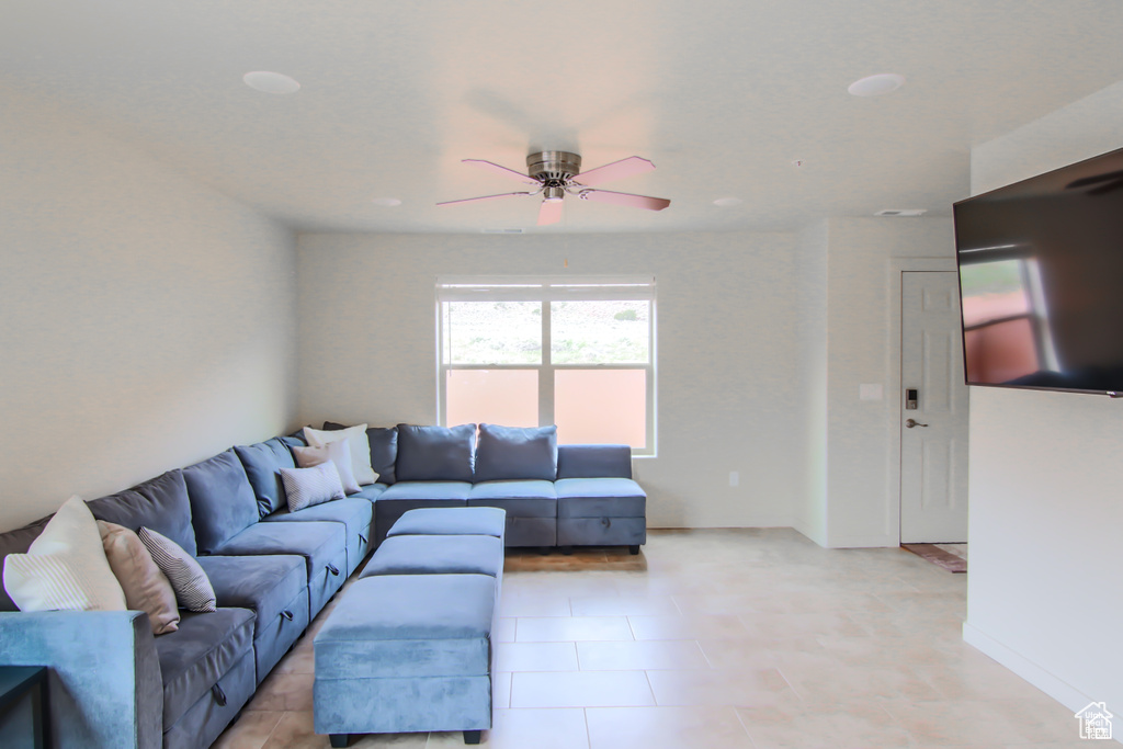 Living room with ceiling fan and baseboards
