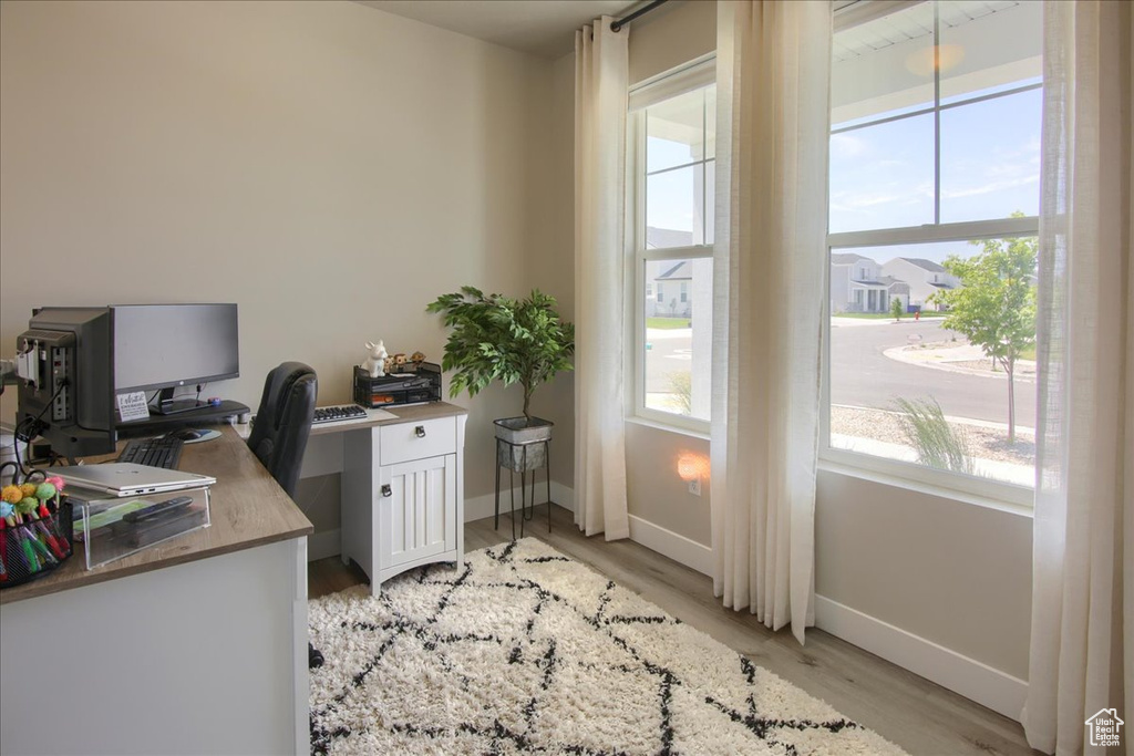 Office space featuring baseboards and light wood-type flooring