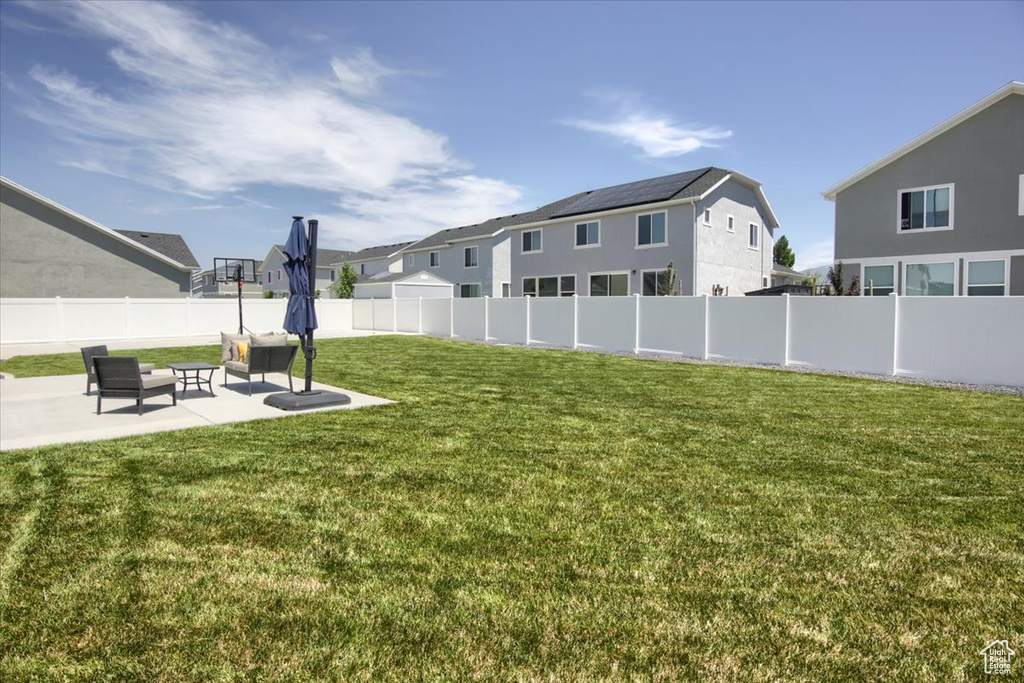 View of yard featuring a patio, a residential view, and an outdoor hangout area