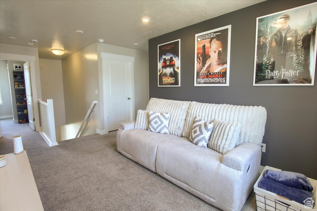 Living area featuring carpet, baseboards, and recessed lighting