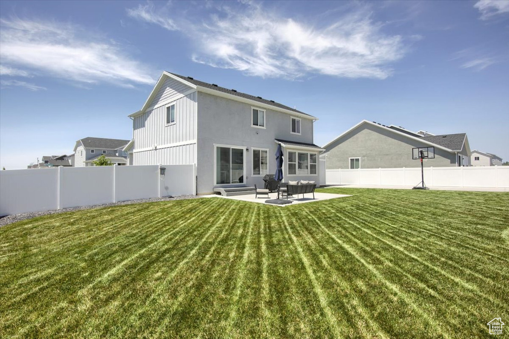 Back of property with a patio