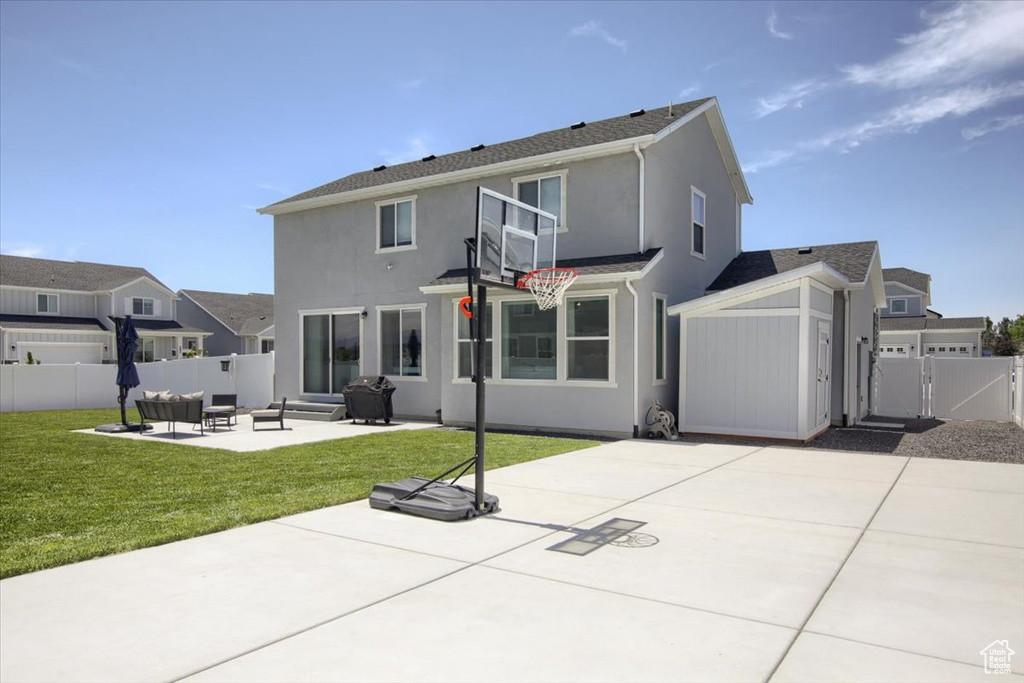 Back of property with a patio area, a gate, outdoor lounge area, and stucco siding