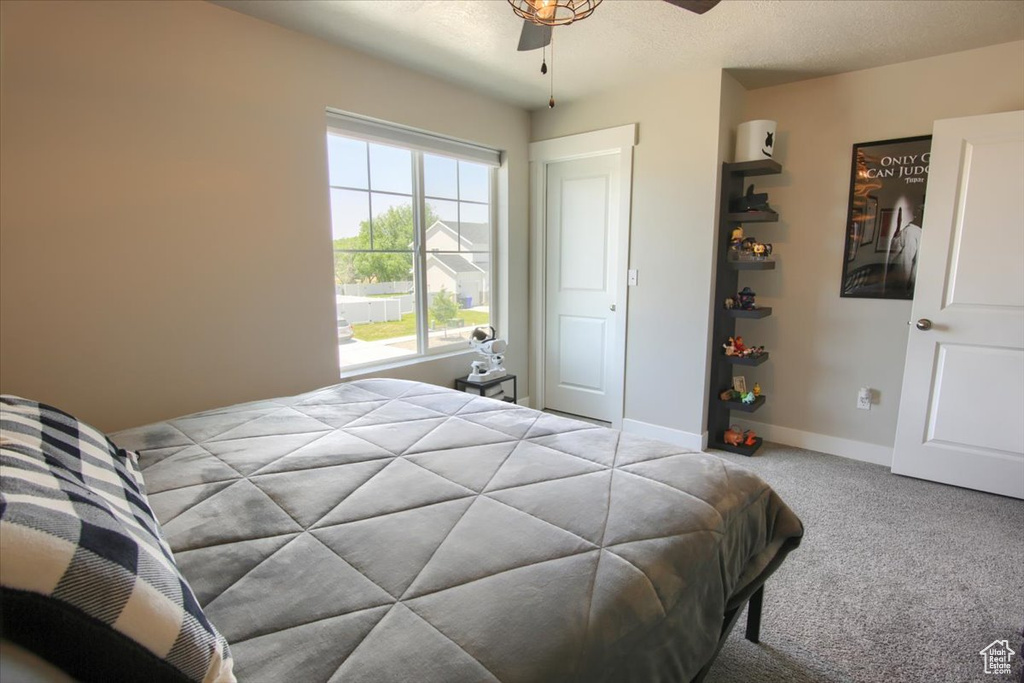 Bedroom with carpet, baseboards, and ceiling fan