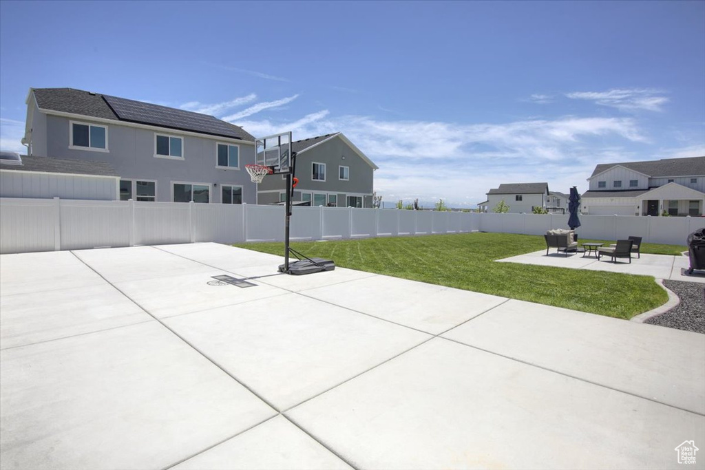 View of patio featuring a fire pit and a residential view