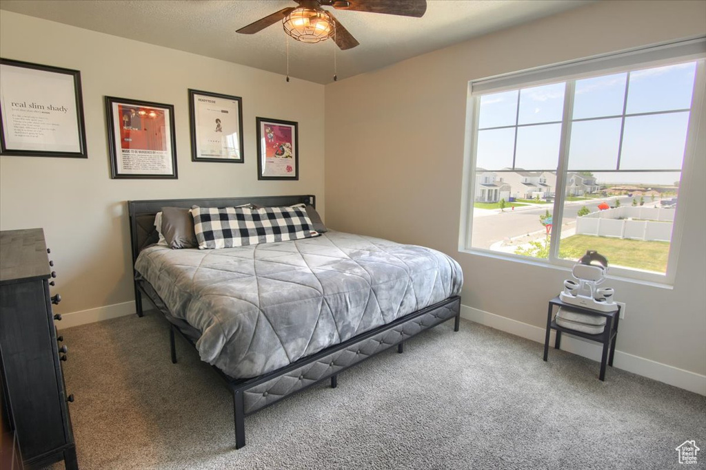 Bedroom featuring carpet, baseboards, and a ceiling fan