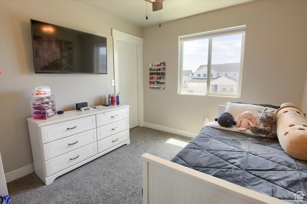 Bedroom with light colored carpet and baseboards