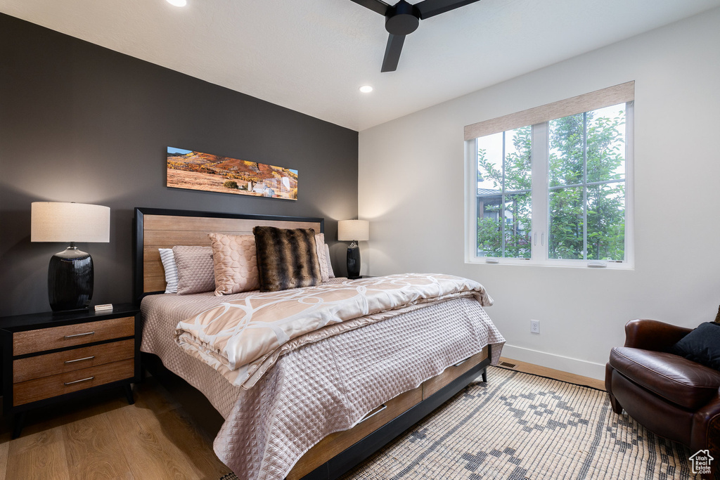 Bedroom featuring wood finished floors, baseboards, recessed lighting, and a ceiling fan